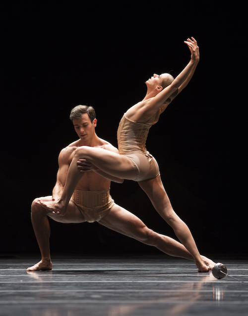 Jerome holds Lesley's front foot as Lesley lunges and extends her arms behind her